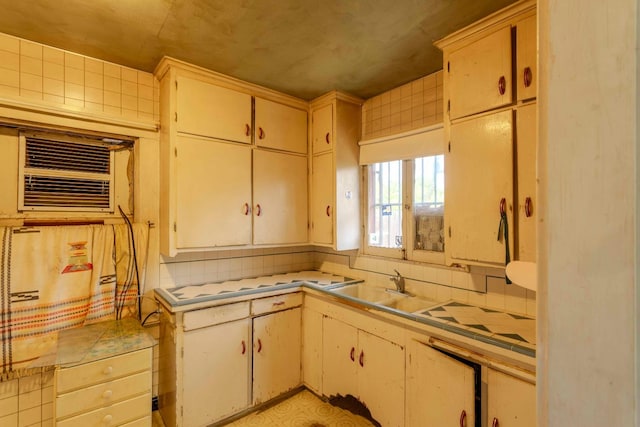 1007 E Michigan Ave, Fresno, CA 93704 - kitchen with a sink, tile countertops, and decorative backsplash