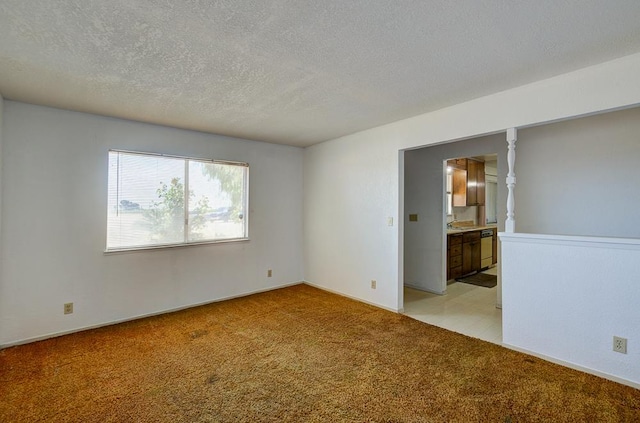 2100 E Linden Ave, Fresno, CA 93725 - unfurnished bedroom featuring light carpet, ensuite bathroom, and a textured ceiling
