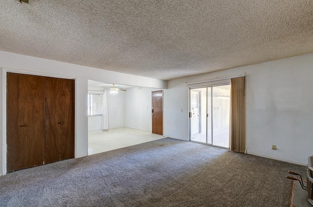 2100 E Linden Ave, Fresno, CA 93725 - unfurnished living room with carpet flooring, a textured ceiling, and ceiling fan