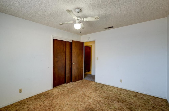 2100 E Linden Ave, Fresno, CA 93725 - unfurnished bedroom with carpet flooring, a closet, a textured ceiling, baseboards, and ceiling fan
