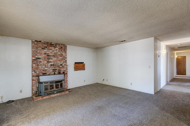 2100 E Linden Ave, Fresno, CA 93725 - unfurnished living room with carpet flooring, a wood stove, and a textured ceiling