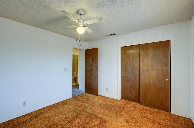 2100 E Linden Ave, Fresno, CA 93725 - unfurnished bedroom featuring carpet flooring, a closet, a textured ceiling, and a ceiling fan