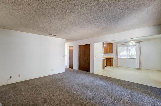 2100 E Linden Ave, Fresno, CA 93725 - unfurnished living room with light carpet, a textured ceiling, and ceiling fan