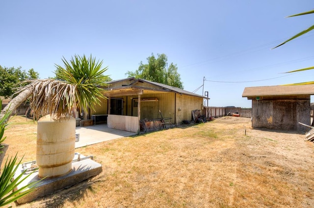 2100 E Linden Ave, Fresno, CA 93725 - rear view of property with an outdoor structure and a patio