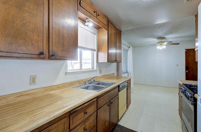 2100 E Linden Ave, Fresno, CA 93725 - kitchen featuring range with gas cooktop, dishwasher, a sink, a ceiling fan, and a textured ceiling