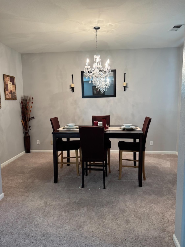 5312 W Cotton Ave, Fresno, CA 93722 - carpeted dining area with a chandelier and baseboards