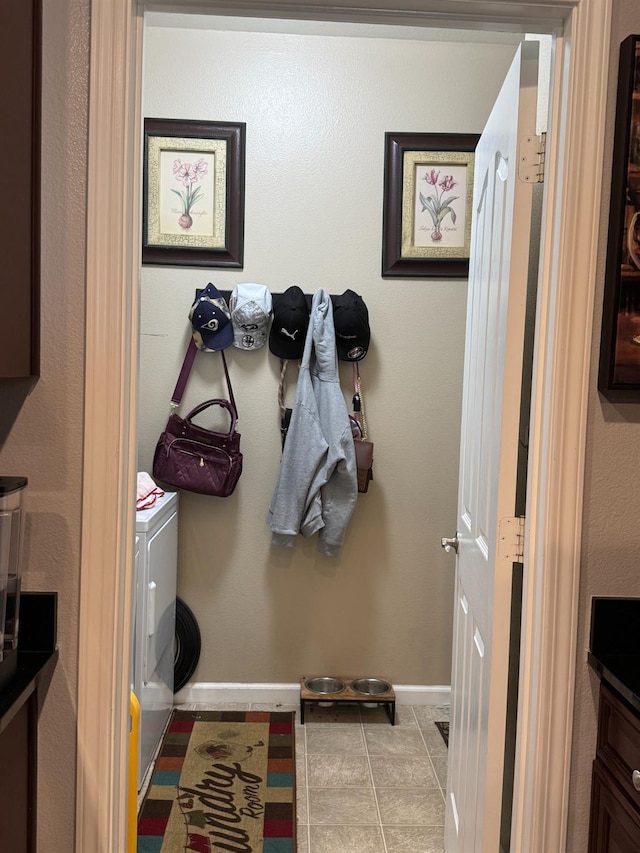 5312 W Cotton Ave, Fresno, CA 93722 - laundry room with baseboards, tile patterned flooring, and washing machine and dryer