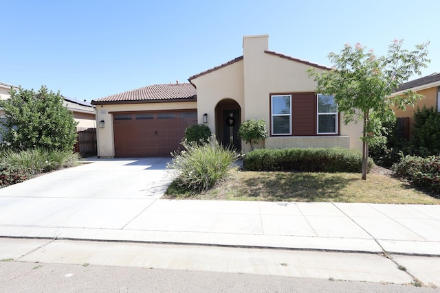 4090 Buckingham Ave, Clovis, CA 93619 - mediterranean / spanish house with stucco siding, an attached garage, a tile roof, and driveway