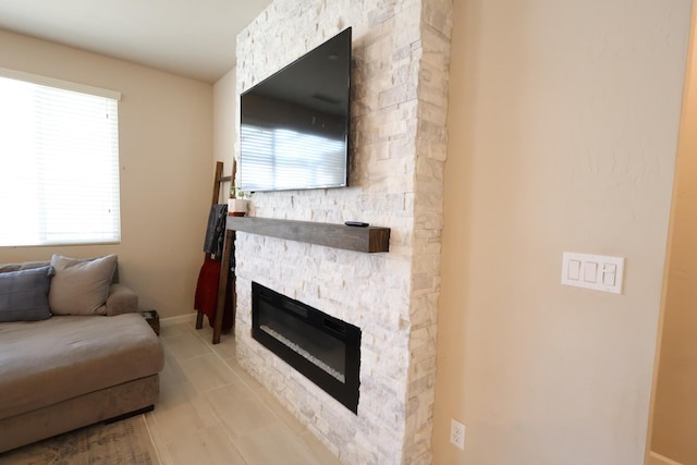 4090 Buckingham Ave, Clovis, CA 93619 - living room featuring a stone fireplace, tile patterned flooring, and baseboards
