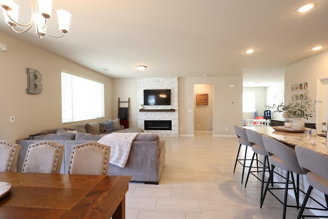 4090 Buckingham Ave, Clovis, CA 93619 - dining area with a chandelier, recessed lighting, a stone fireplace, and baseboards