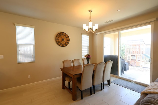 4090 Buckingham Ave, Clovis, CA 93619 - dining area featuring a chandelier and baseboards