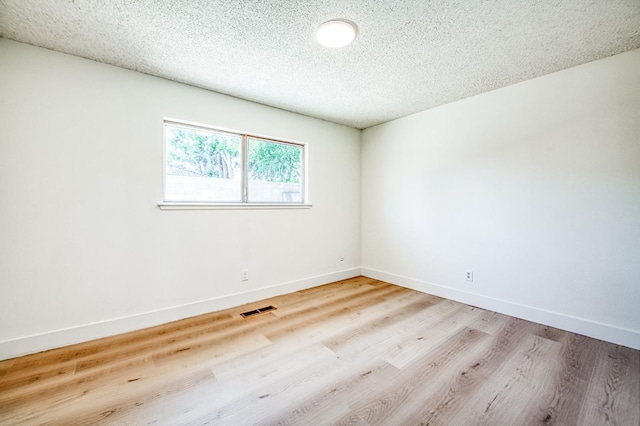 1448 N Helm Ave, Fresno, CA 93727 - spare room with wood finished floors, baseboards, and a textured ceiling