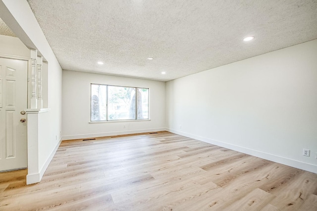 1448 N Helm Ave, Fresno, CA 93727 - empty room featuring a textured ceiling, recessed lighting, light wood-type flooring, and baseboards