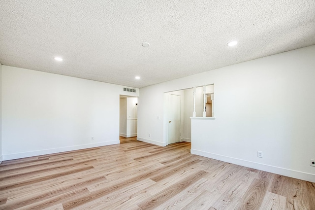 1448 N Helm Ave, Fresno, CA 93727 - spare room with a textured ceiling, light wood-type flooring, recessed lighting, and baseboards