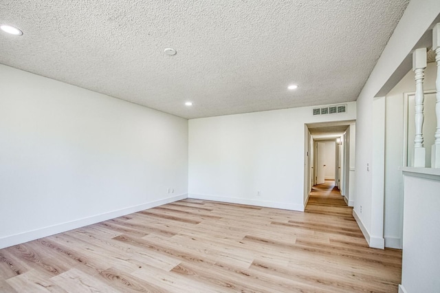 1448 N Helm Ave, Fresno, CA 93727 - spare room featuring light wood-type flooring, recessed lighting, a textured ceiling, and baseboards