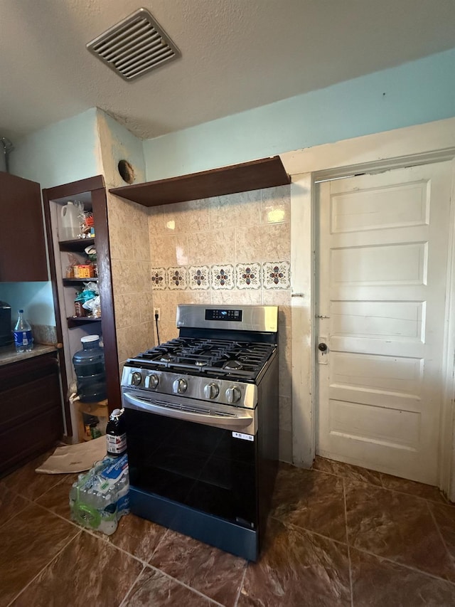 1128 Kern St, Fresno, CA 93706 - kitchen with gas stove and decorative backsplash