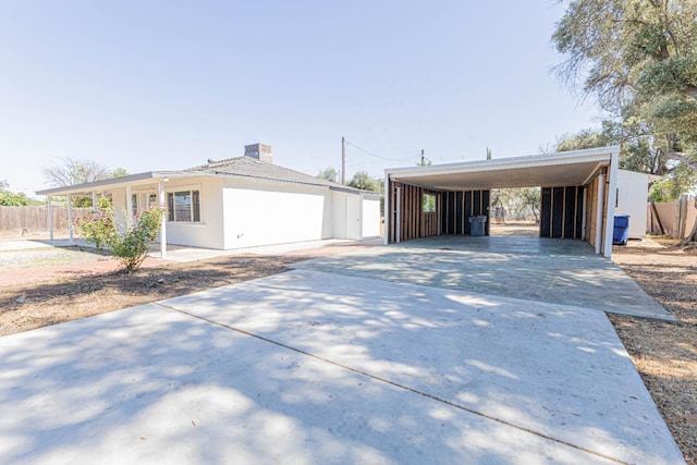 4930 E Olive Ave, Fresno, CA 93727 - view of front of property with concrete driveway and an attached carport