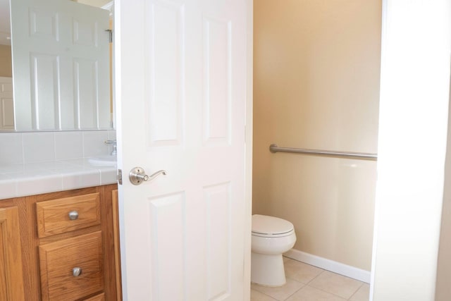 1850 N Dupree Ln, Clovis, CA 93619 - bathroom with tile patterned flooring, toilet, vanity, and baseboards