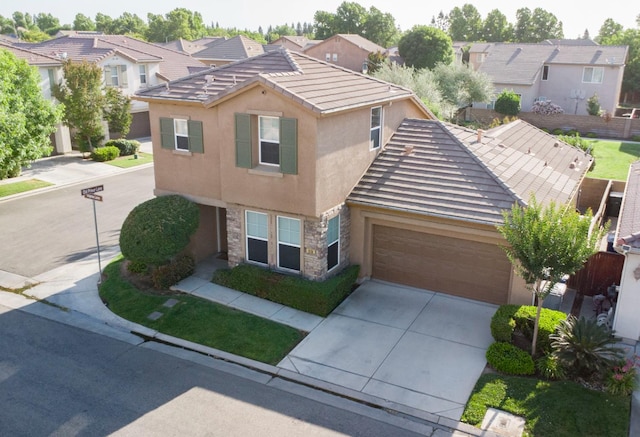 1850 N Dupree Ln, Clovis, CA 93619 - view of front facade featuring stucco siding, driveway, a garage, stone siding, and a tiled roof