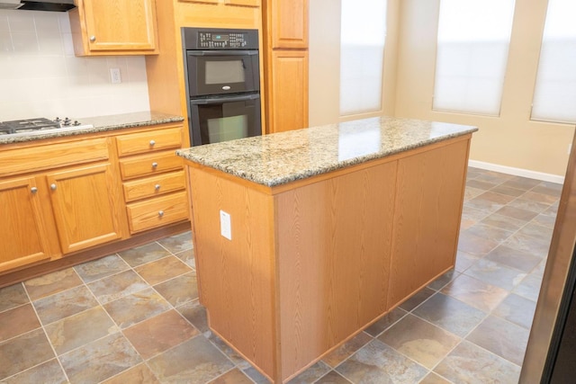 1850 N Dupree Ln, Clovis, CA 93619 - kitchen with gas cooktop, a center island, light stone counters, range hood, and backsplash