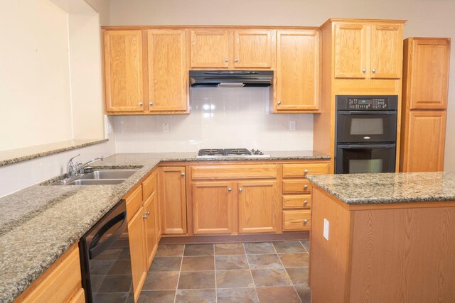 1850 N Dupree Ln, Clovis, CA 93619 - kitchen with under cabinet range hood, black appliances, a sink, light stone counters, and tasteful backsplash