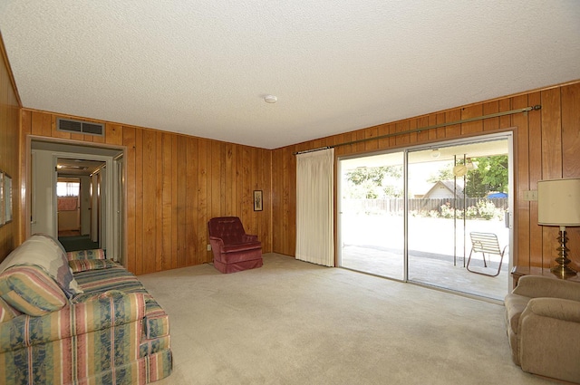 1692 W Tenaya Way, Fresno, CA 93711 - living room with wood walls, light colored carpet, and a textured ceiling