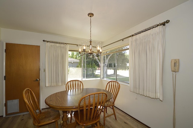 1692 W Tenaya Way, Fresno, CA 93711 - dining space with wood finished floors, healthy amount of natural light, and a chandelier