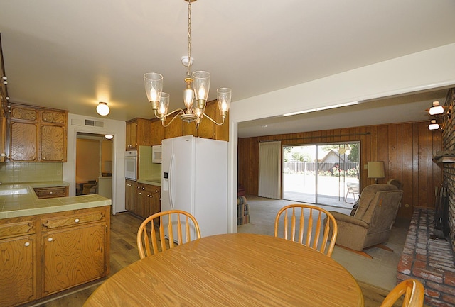 1692 W Tenaya Way, Fresno, CA 93711 - dining room with a chandelier and wood walls