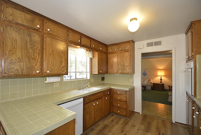 1692 W Tenaya Way, Fresno, CA 93711 - kitchen featuring white appliances, a sink, tile counters, brown cabinets, and tasteful backsplash
