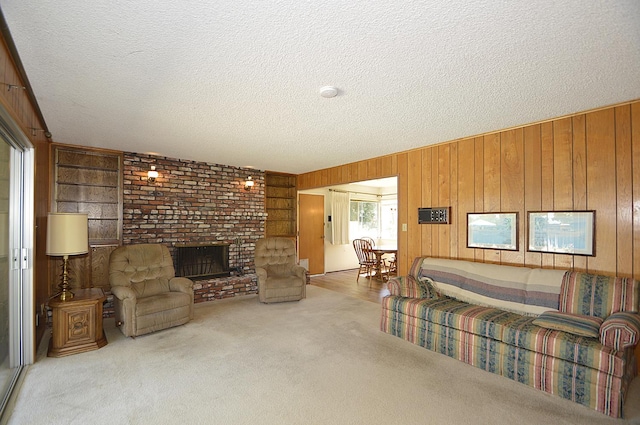1692 W Tenaya Way, Fresno, CA 93711 - living room featuring wood walls, carpet flooring, a textured ceiling, and a brick fireplace