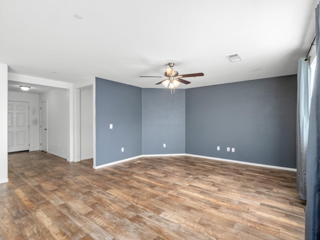 703 Tulip Cir, Dinuba, CA 93618 - spare room featuring ceiling fan, wood finished floors, and baseboards