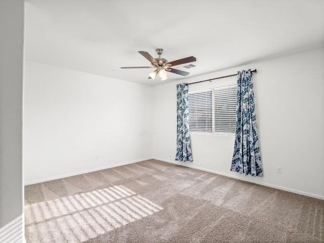 703 Tulip Cir, Dinuba, CA 93618 - carpeted spare room featuring a ceiling fan and baseboards