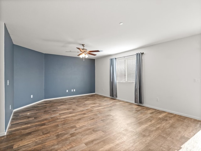 703 Tulip Cir, Dinuba, CA 93618 - spare room featuring wood finished floors, a ceiling fan, and baseboards
