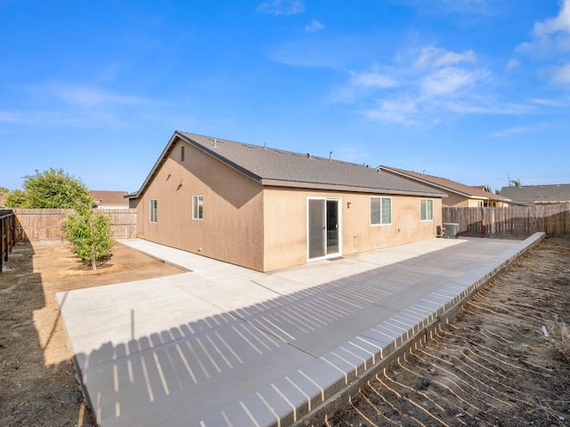 703 Tulip Cir, Dinuba, CA 93618 - back of house with a patio area, a fenced backyard, and stucco siding