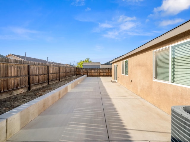 703 Tulip Cir, Dinuba, CA 93618 - fenced backyard with central air condition unit and a patio