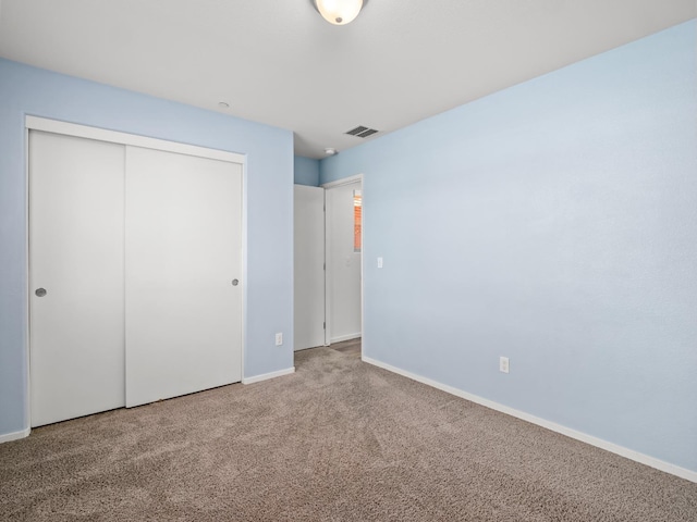 703 Tulip Cir, Dinuba, CA 93618 - unfurnished bedroom with carpet, a closet, and baseboards