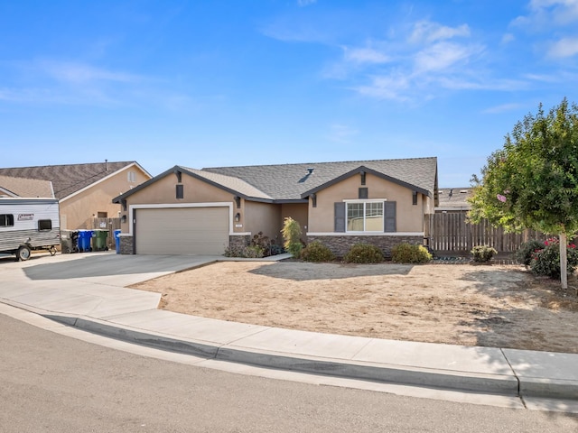 703 Tulip Cir, Dinuba, CA 93618 - single story home featuring stucco siding, stone siding, driveway, and an attached garage
