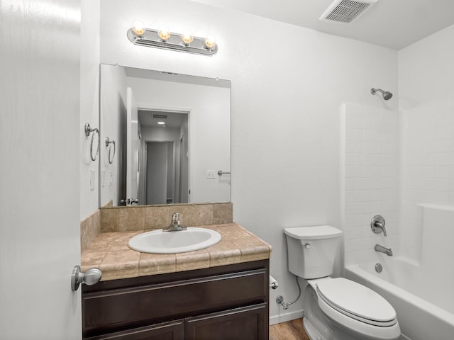 703 Tulip Cir, Dinuba, CA 93618 - full bathroom with toilet, vanity, shower / washtub combination, and wood finished floors