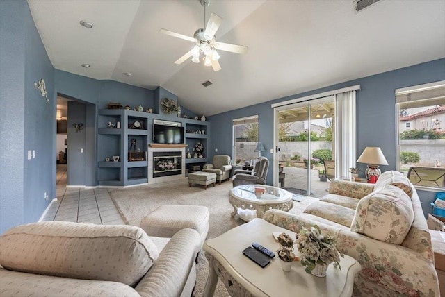 3159 Cedar Creek Ln, Madera, CA 93637 - tiled living area with lofted ceiling, a ceiling fan, and a glass covered fireplace
