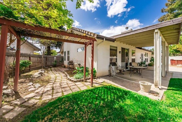 3159 Cedar Creek Ln, Madera, CA 93637 - rear view of house featuring a patio, a fenced backyard, and stucco siding