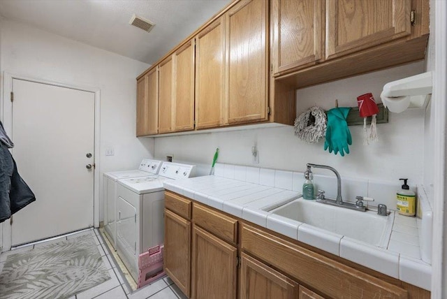 3159 Cedar Creek Ln, Madera, CA 93637 - washroom featuring cabinet space, separate washer and dryer, and light tile patterned flooring