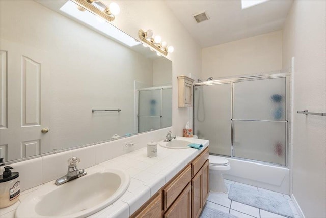 3159 Cedar Creek Ln, Madera, CA 93637 - full bath with double vanity, combined bath / shower with glass door, toilet, and tile patterned flooring