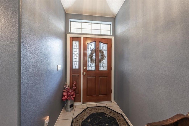 3159 Cedar Creek Ln, Madera, CA 93637 - doorway with tile patterned floors, a textured wall, and baseboards