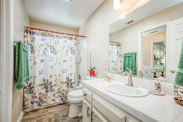 1183 E Dinuba Ave, Fresno, CA 93725 - full bathroom with wood finished floors, vanity, toilet, and shower / bath combo