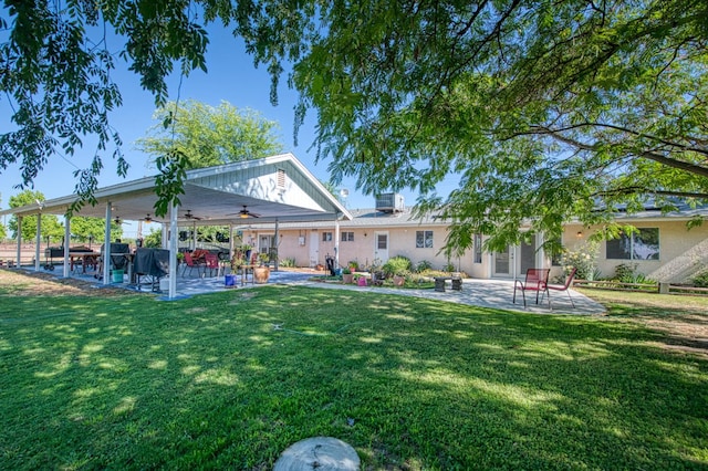 1183 E Dinuba Ave, Fresno, CA 93725 - rear view of property with a ceiling fan, a patio, and a yard