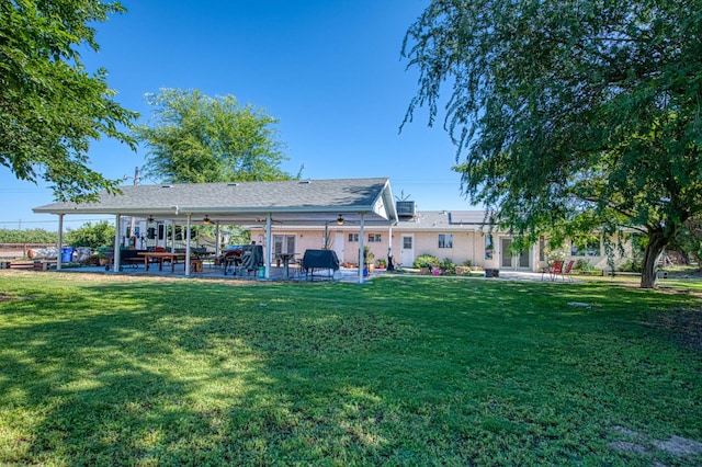 1183 E Dinuba Ave, Fresno, CA 93725 - rear view of property with a ceiling fan, roof mounted solar panels, a patio, and a yard