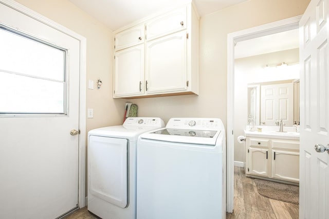 1183 E Dinuba Ave, Fresno, CA 93725 - washroom featuring cabinet space, washing machine and clothes dryer, and light wood-type flooring