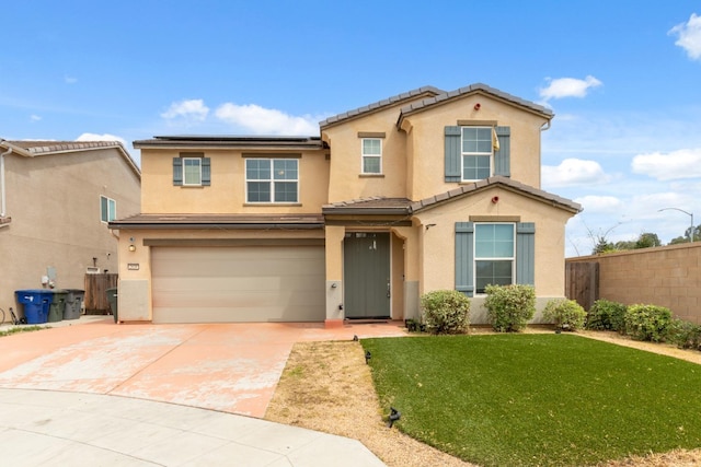 2830 Leanna Ave, Fresno, CA 93737 - view of front facade with driveway, roof mounted solar panels, an attached garage, stucco siding, and a tiled roof