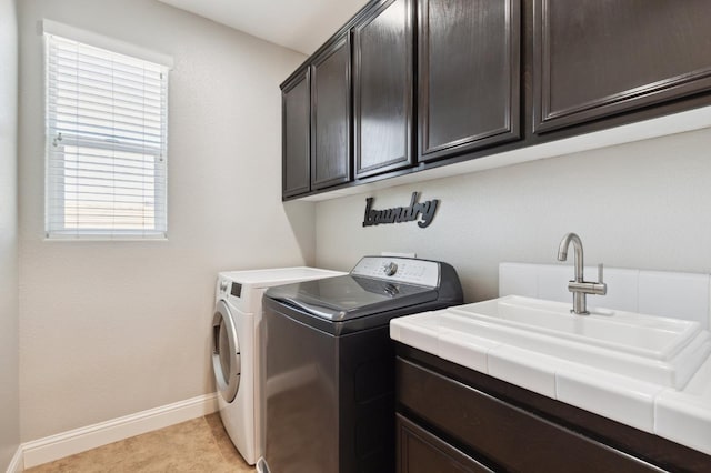 1697 Whiteash Ave, Clovis, CA 93619 - laundry room featuring cabinet space, washing machine and clothes dryer, baseboards, and light tile patterned flooring