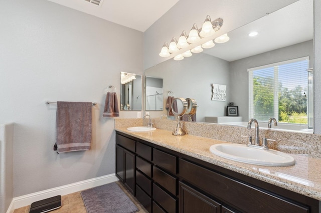 1697 Whiteash Ave, Clovis, CA 93619 - bathroom with double vanity, baseboards, and tile patterned floors